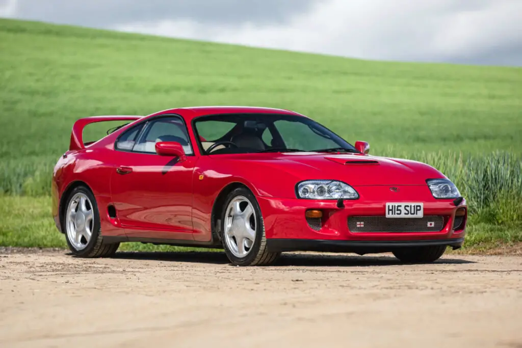 1996 Toyota Supra A80 twin-turbo in front of grass
